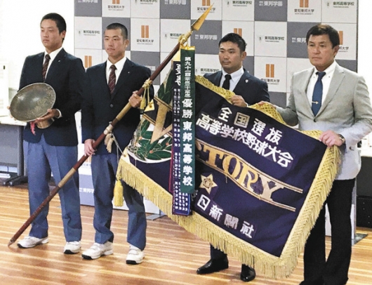 優勝旗や優勝杯と記念写真に納まる東邦高の（左から）吉納副主将、林主将、山田祐輔監督、森田泰弘総監督＝６日午後、名古屋市の同校で