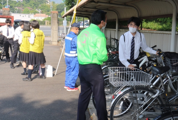 登校してきた生徒に自転車の安全利用などを呼び掛ける署員（右から２人目）ら＝多治見市明和町の多治見西高で