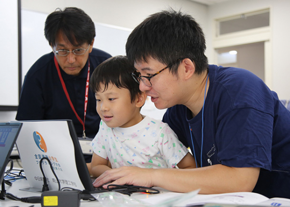教室に参加する親子と指導する蜂巣教授（左）＝名古屋市昭和区の南山大で