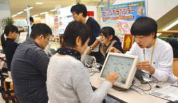 脳年齢の検査を買い物客に実施する学生たち＝２０日、関市倉知のマーゴで