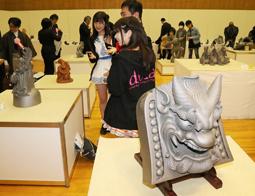「飾り瓦コンクール」の応募作品を見る人たち=高浜市のかわら美術館で