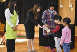 園児に紙芝居を渡す学生たち＝天白区の上ノ池保育園で