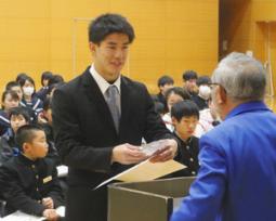 桑原会長（右）から表彰状と盾を受け取った堀島選手＝揖斐川町健康広場で