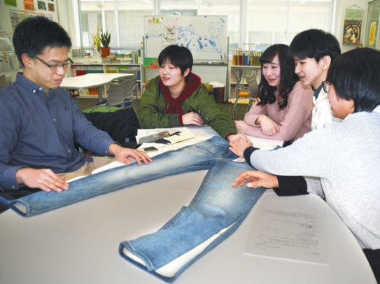 リメークが完成したジーンズを確認する唐田宏樹さん（左）ら「ユニこまＰｌｕｓ＋」のメンバーたち＝愛知県長久手市で