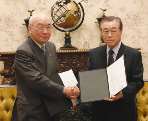 連携協定書に署名し、交換する杉浦学長（左）と大島理事長＝昭和区内で
